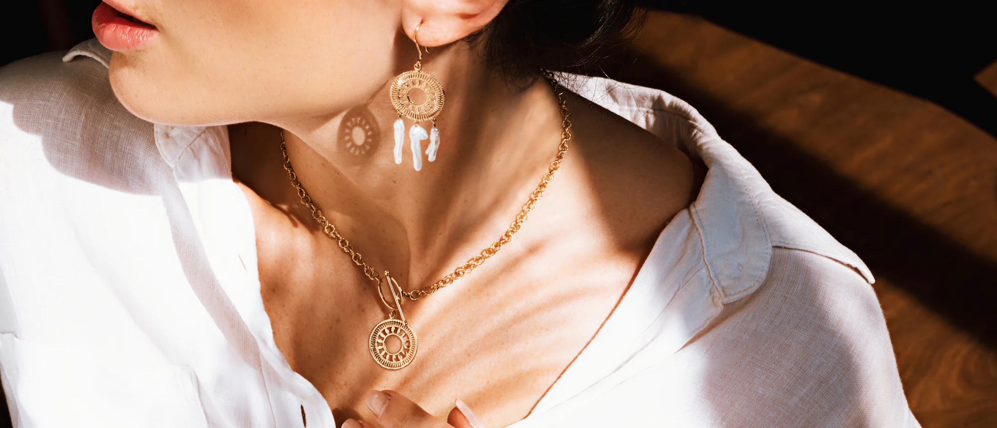 A woman wearing a delicate gold necklace