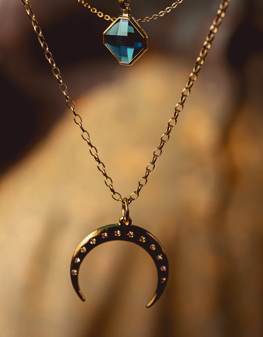 Gold necklaces with a blue gemstone pendant