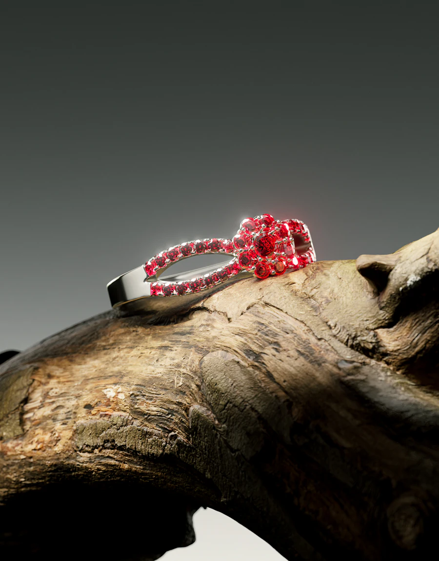 A red gemstone ring resting on weathered wood