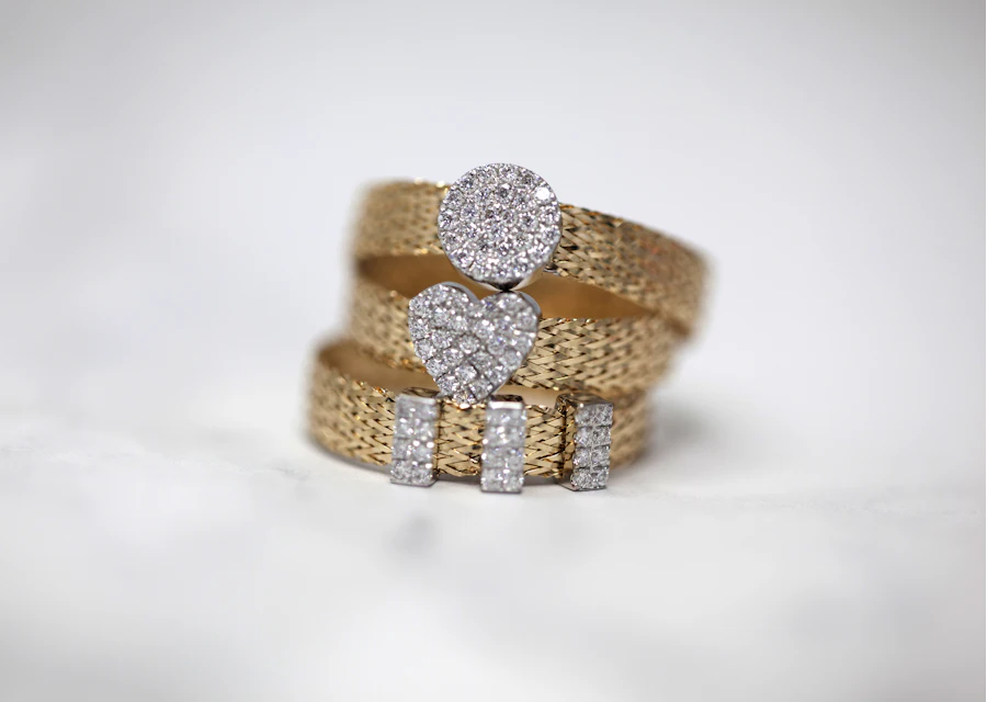 Three gold rings set with small stones